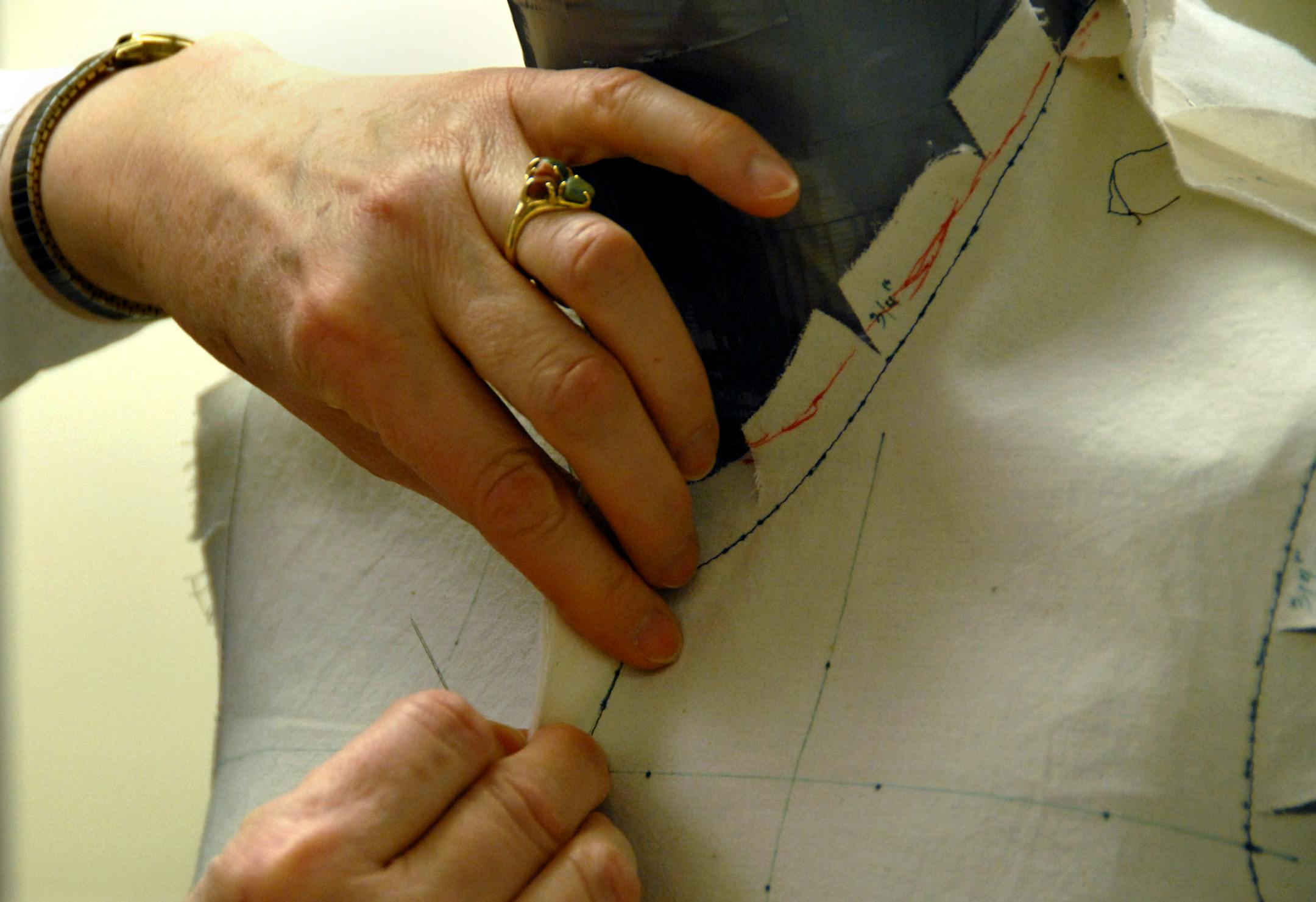 Karen Ryan, research associate in clothing design at the University of Minnesota, pinned a muslin pattern on the dress form she modified with padding and duct tape to resemble a woman suffering from osteoporosis.