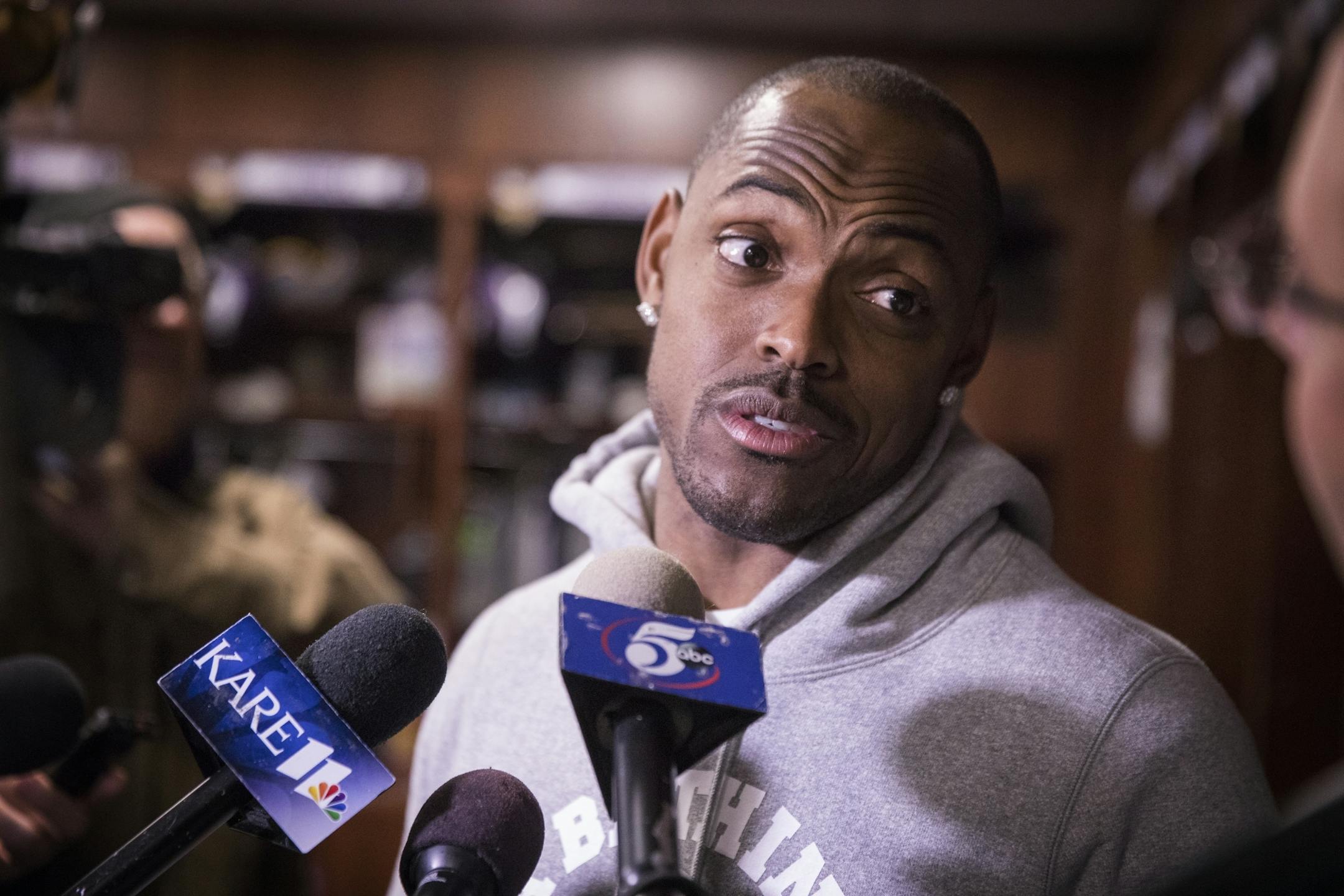Captain Munnerlyn speaks with the media in front of his locker.