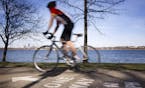 A bicyclist rides along the bike path around Lake Calhoun in Minneapolis on Wednesday, April 15, 2015. ] LEILA NAVIDI leila.navidi@startribune.com / B