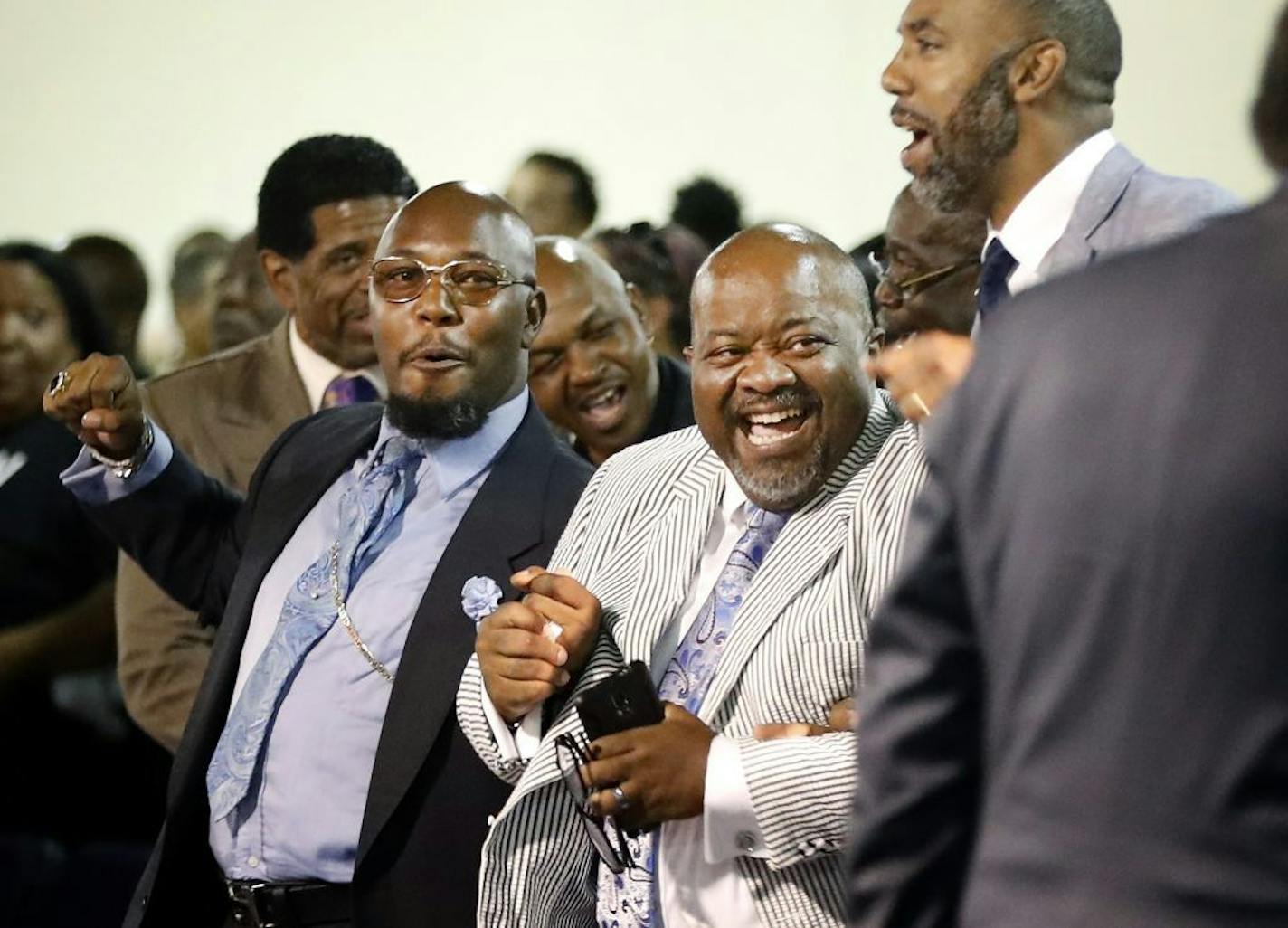 Bishop DL Bryant-Kemp of the New Mt. Calvary Missionary Baptist Church, Pastor Spence of the New Hope Baptist Church and Pastor Melvin Miller at Progressive Baptist Church enjoyed a lighthearted moment during a service at the Shiloh Temple International Ministries in Minneapolis.