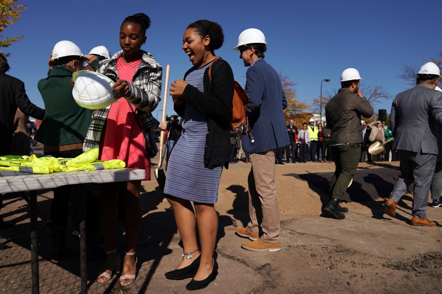 Ramiyah Jackson, left, and Imani Harris, who sang early in the program donned hardhats for a photo during the groundbreaking ceremony.