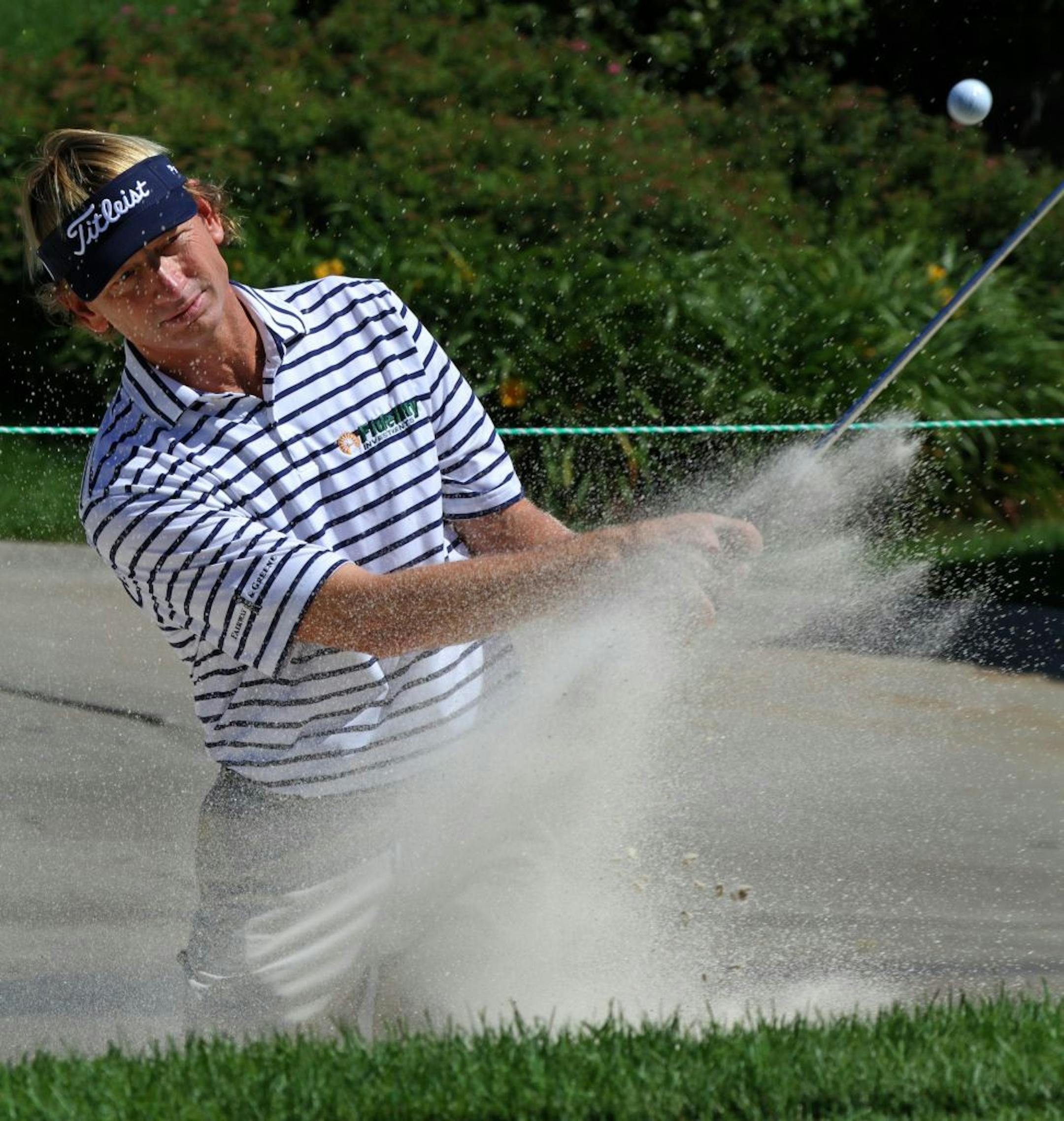 Brad Faxon blasted out of the sand trap as he practiced on the putting green before starting the Insight Pro-Am, part of 3M Championship week, on Wednesday.