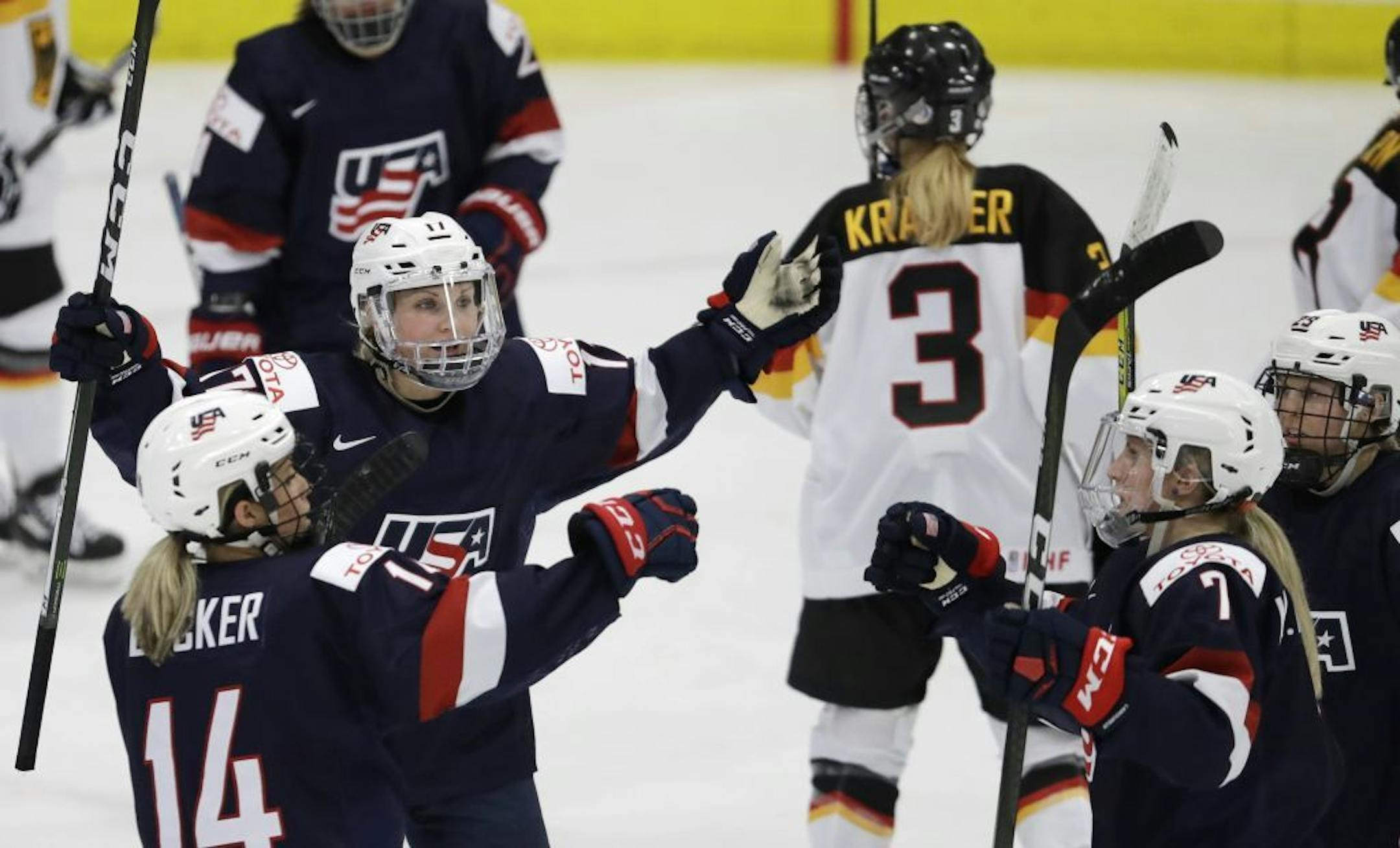 United States forwards Jocelyne Lamoureux-Davidson (17) and Brianna Decker (14) greet defender Monique Lamoureux (7) after her goal during the third period of a IIHF Women's World Championship semifinal hockey tournament game against Germany, Thursday, April 6, 2017, in Plymouth, Mich. The US won 11-0.
