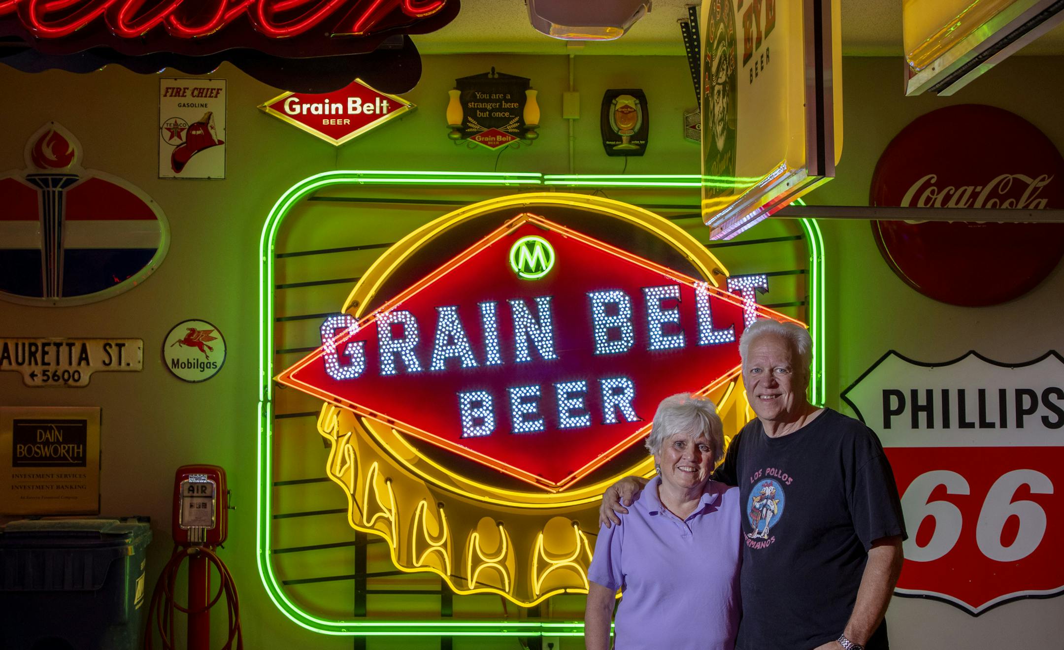Sharolyn and Scott Erie photographed in their garage with a Grain Belt sign made by Scott. ] CARLOS GONZALEZ • cgonzalez@startribune.com – Eagan, MN – October 8, 2020, Scott and Sharolyn Erie have been using their fancy garage to host socially distanced, well-ventilated gatherings.
