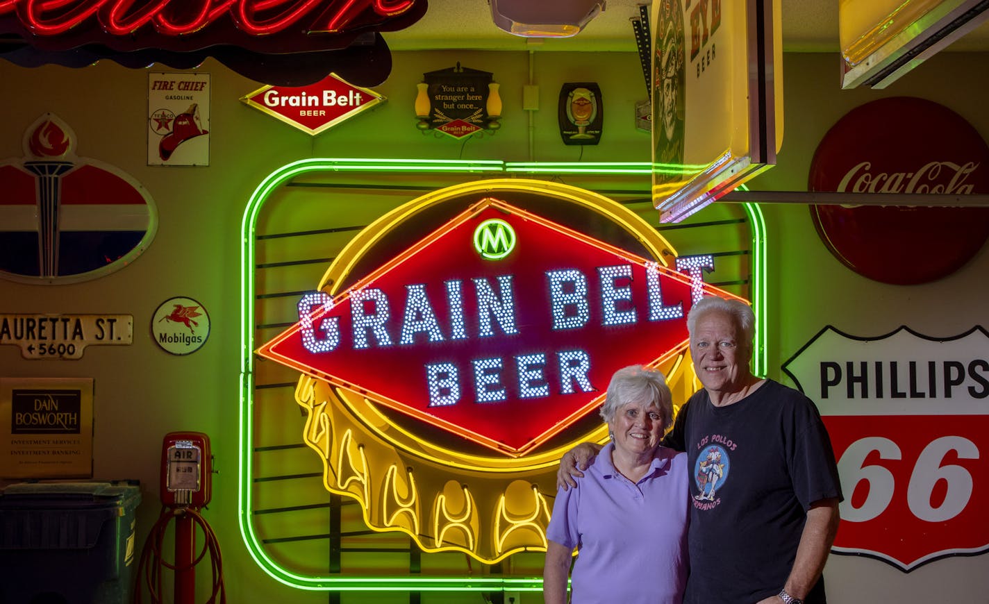 Sharolyn and Scott Erie photographed in their garage with a Grain Belt sign made by Scott. ] CARLOS GONZALEZ • cgonzalez@startribune.com – Eagan, MN – October 8, 2020, Scott and Sharolyn Erie have been using their fancy garage to host socially distanced, well-ventilated gatherings.