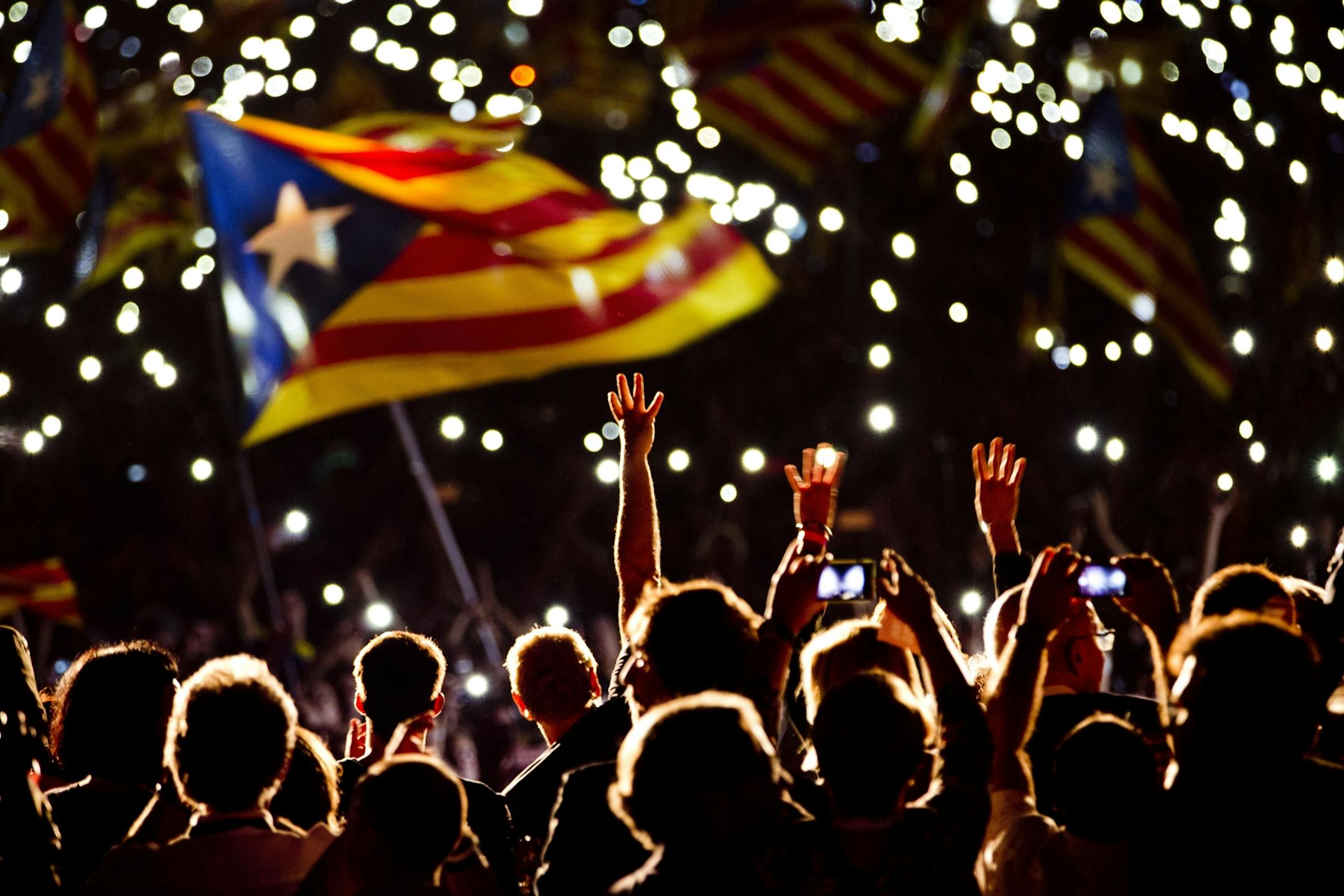 Pro independence supporters wave "estelada" or pro independence flags during a rally of "Junts pel Si" or "Together for YES" in Barcelona, Spain, Friday, Sept. 25, 2015. Catalans vote Sunday in regional parliamentary elections that the breakaway camp hopes will give them a mandate to put their region on a path toward independence _ a goal the Madrid central government says would be illegal. (AP Photo/Emilio Morenatti)