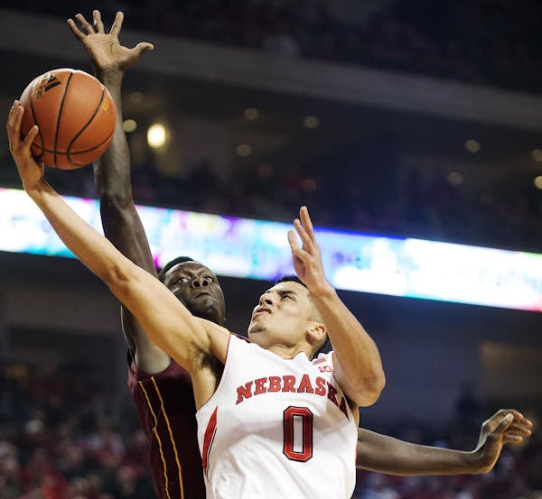 Nebraska guard Tai Webster drove to the basket against Gophers guard Kevin Dorsey during the first half of the Cornhuskers' 84-59 rout in Lincoln, Neb