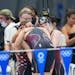 Team USA swimmers Regan Smith, Lydia Jacoby, Torri Huske and Abbey Weitzeil huddled after swimming to silver in the women’s 4x 100 meter medley rela