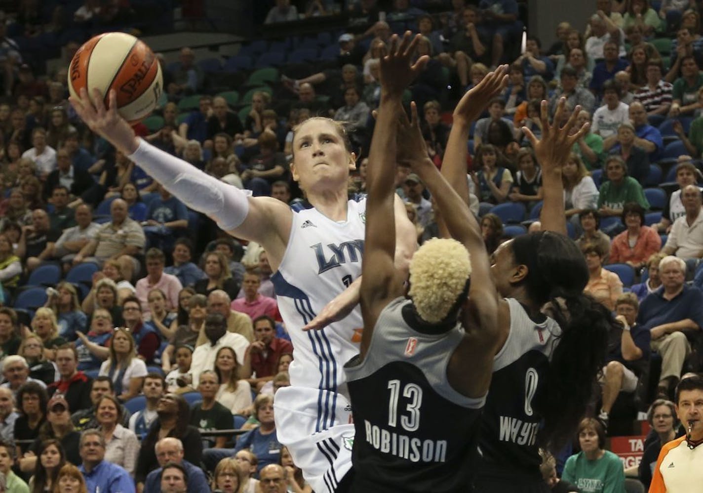 Lynx Lindsay Whalen drove against the double team of San Antonio's Danielle Robinson and Davellyn Whyte during the second half at the Target Center in Minneapolis, Min., Tuesday, June 11, 2013. Lynx won 87-72