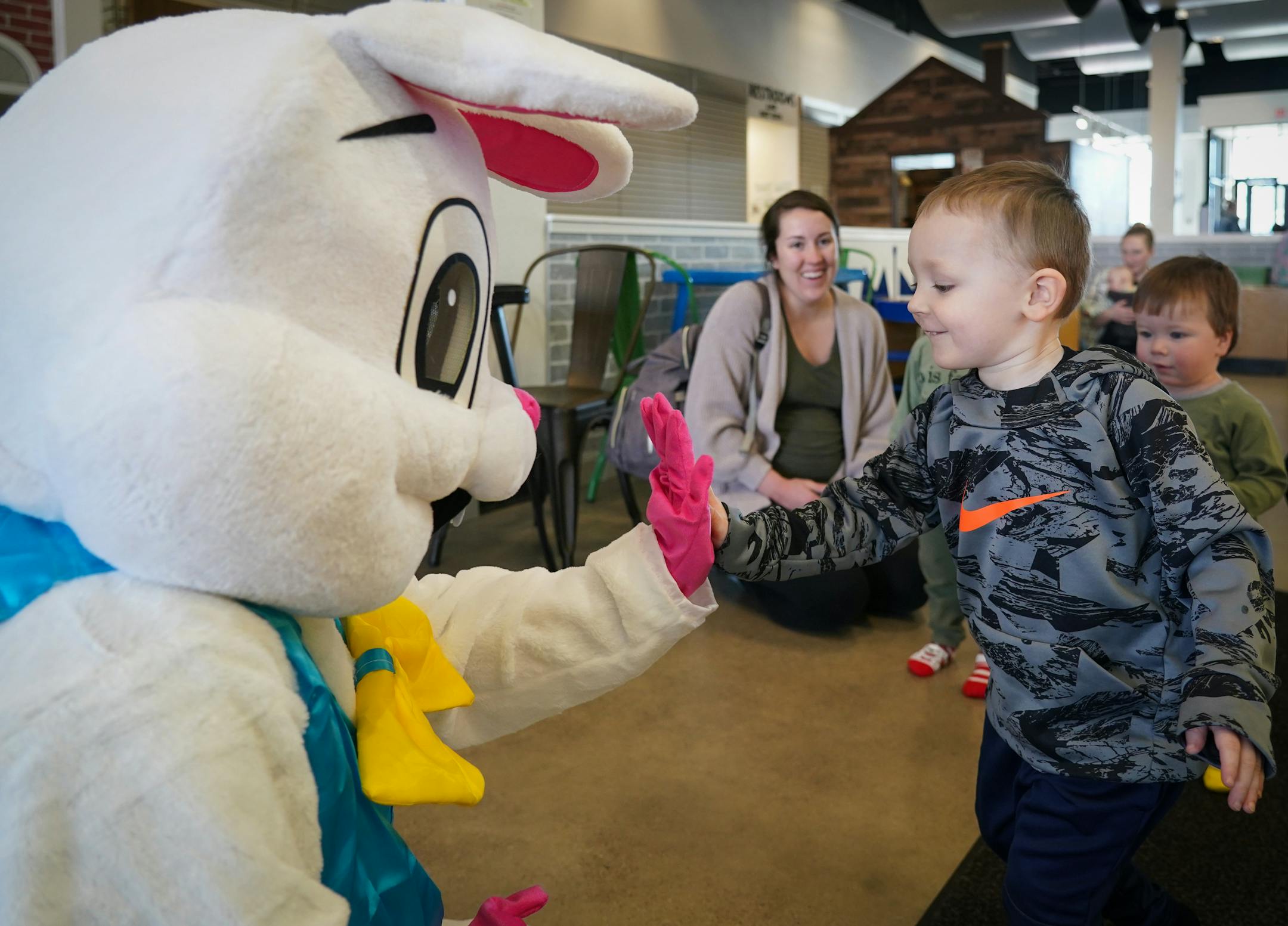 Leo Brabec, 2, gives the Easter Bunny a high-five.