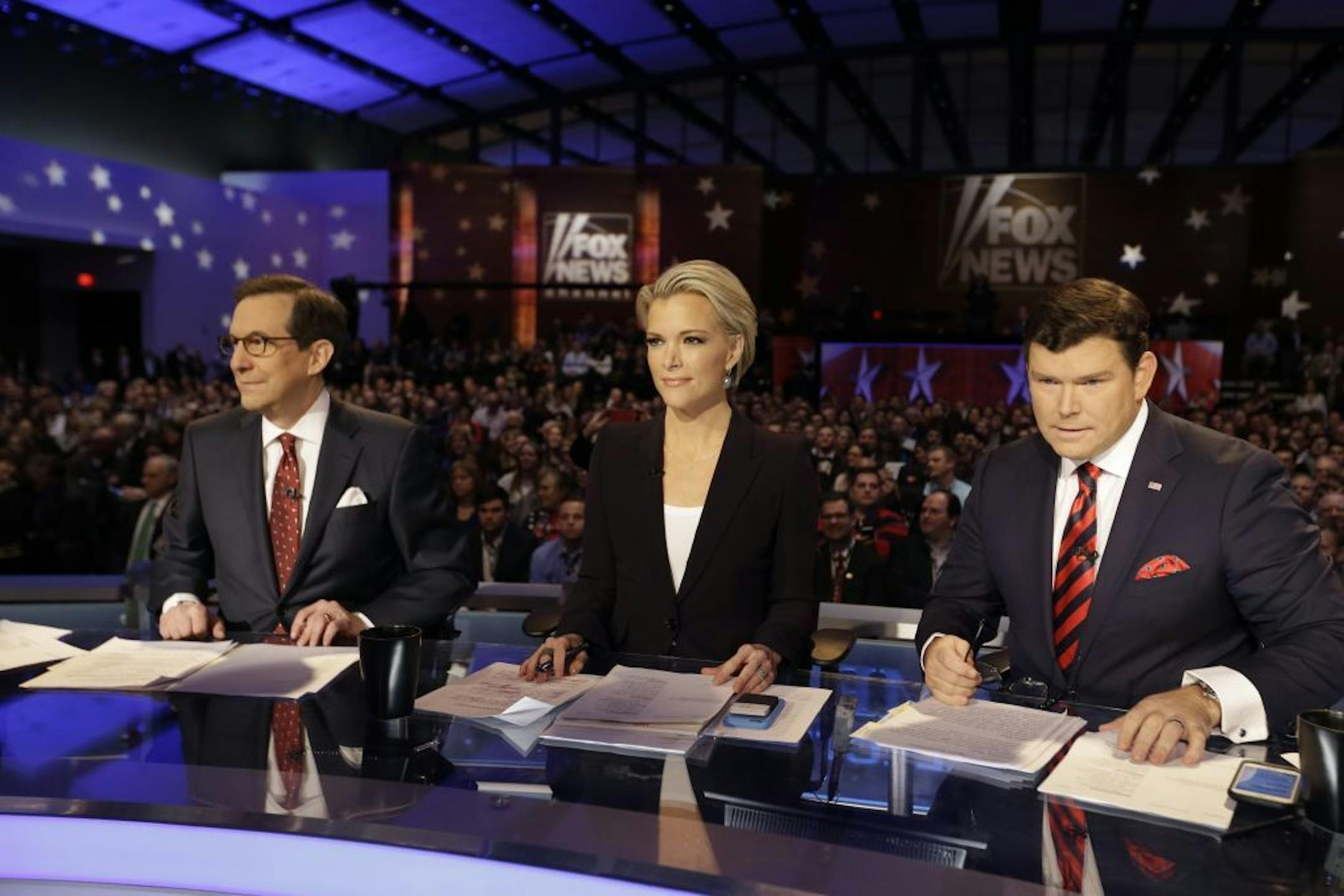 Moderators Chris Wallace, Megyn Kelly and Bret Baier wait for a Republican presidential primary debate, Thursday, Jan. 28, 2016, in Des Moines, Iowa.