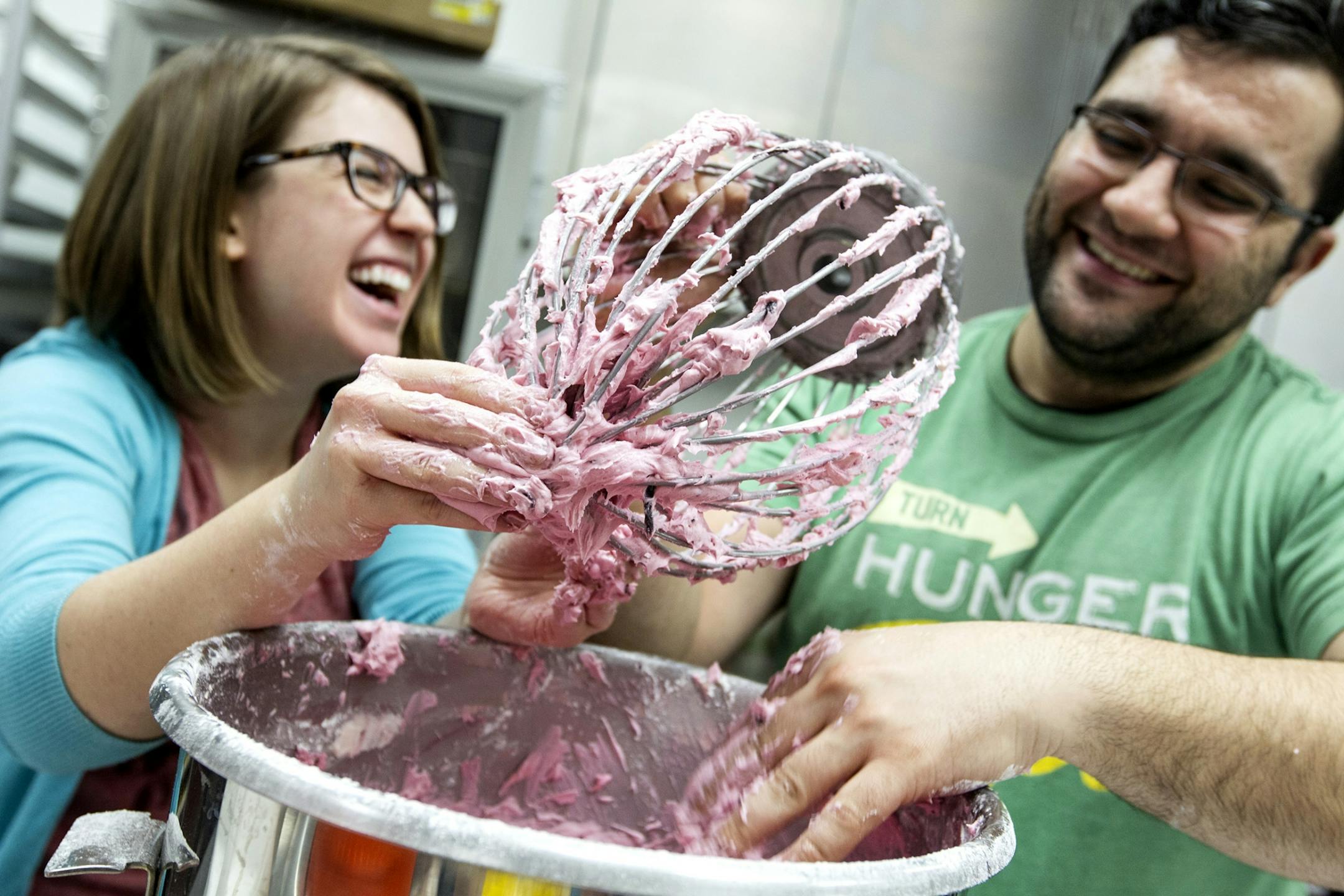 Volunteers Caitlin Duff, left, and Vahid Raboodan make beet icing for a chocolate beet cake at Eat for Equity's community feast benefitting Urban Ventures at the Urban Ventures headquarters in Minneapolis January 31, 2015.