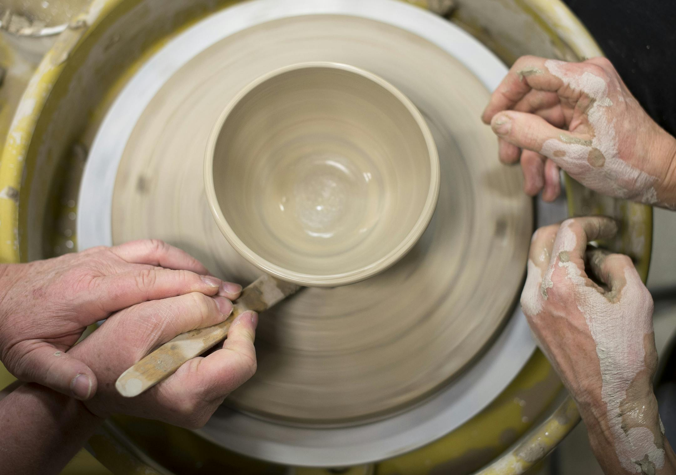 Pottery instructor JoAnne Andres, left, teaches student Jean Meyer how to use an undercutting tool during Andres' class on Thursday night. ] (Aaron Lavinsky | StarTribune) Students at the Lakeville Area Arts Center take a pottery class under the tutelage of instructor JoAnne Andres on Friday, Jan. 9, 2015. The course is six weeks long and provides instruction and hands-on demonstration to students hoping to learn how to hand form and wheel throw pottery.