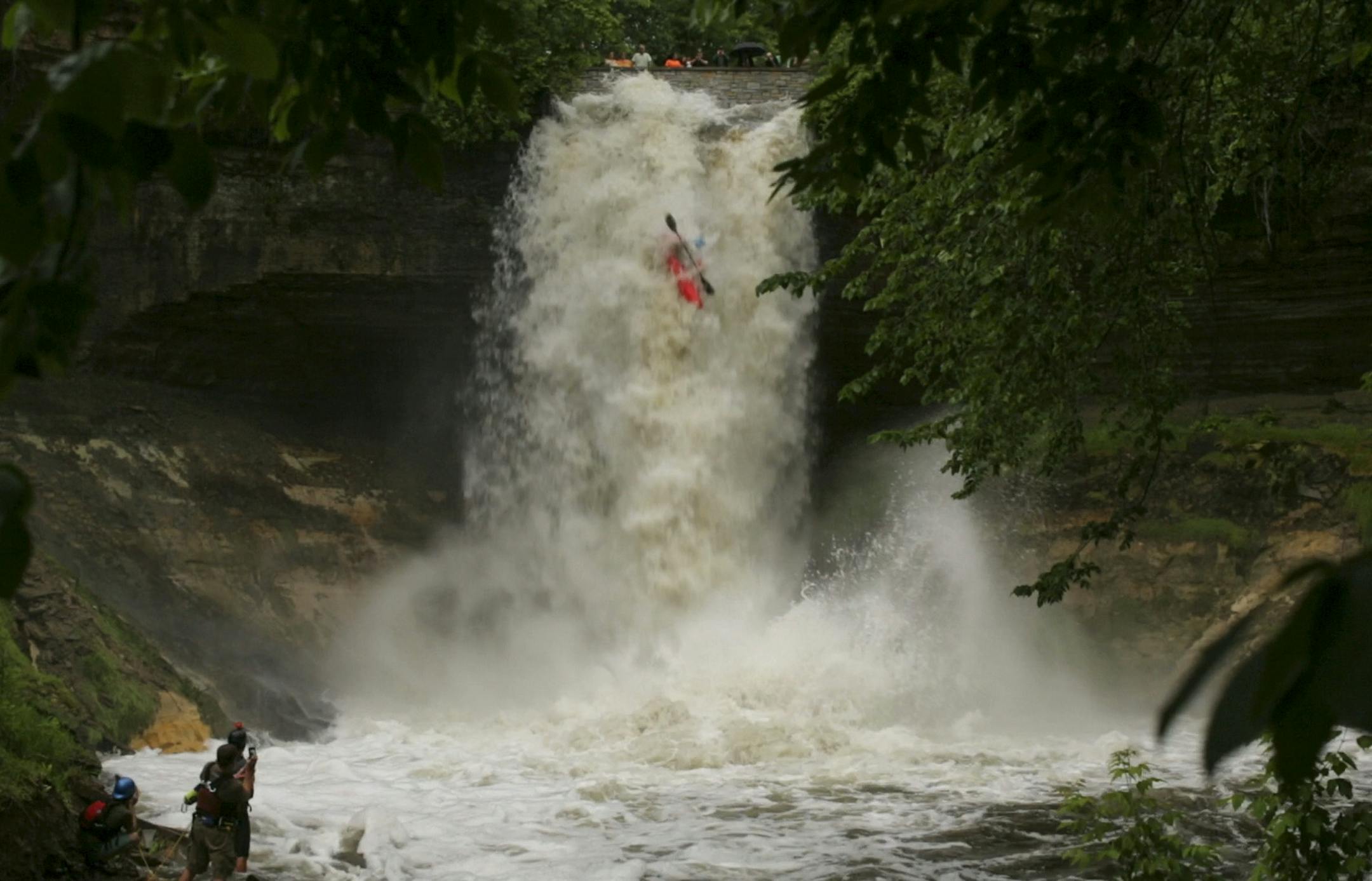 Hunt Jennings held his nose as he reached shore after going over a raging Minnehaha Falls in a kayak Thursday afternoon.