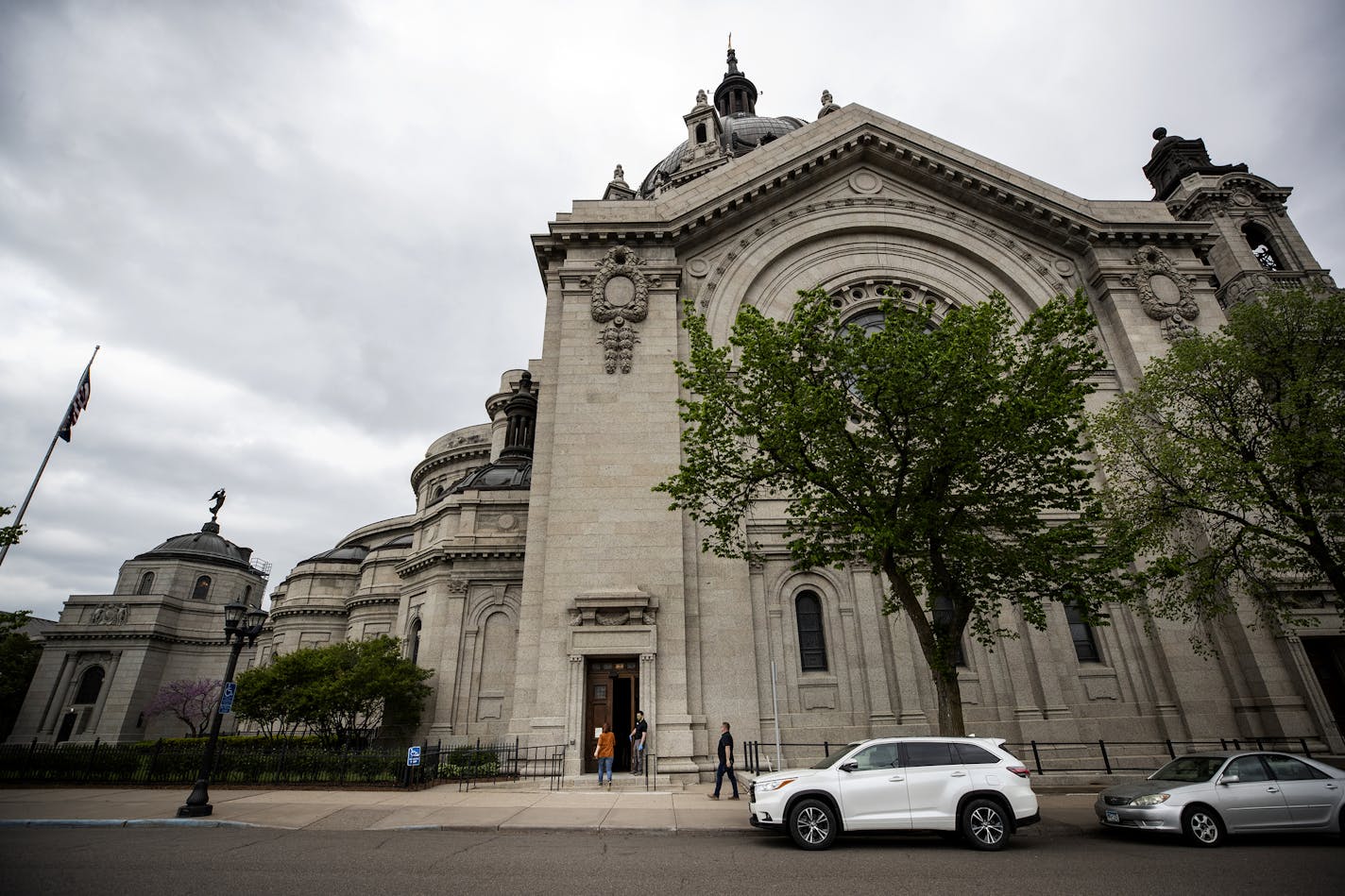 Ben Nelson held the door open for people heading into confession at the St. Paul Cathedral. Nelson works maintenance at the Cathedral. Part of his responsibility include sanitizing and making sure that there are under 10 people inside during confessions. ] CARLOS GONZALEZ • cgonzalez@startribune.com – St. Paul, MN – May 21, 2020, COVID-19, Coronavirus, The St. Paul Cathedral is only open for confessions at this point. You can't just go in. Confession hours are from 3:30 pm to 5 pm, and you need