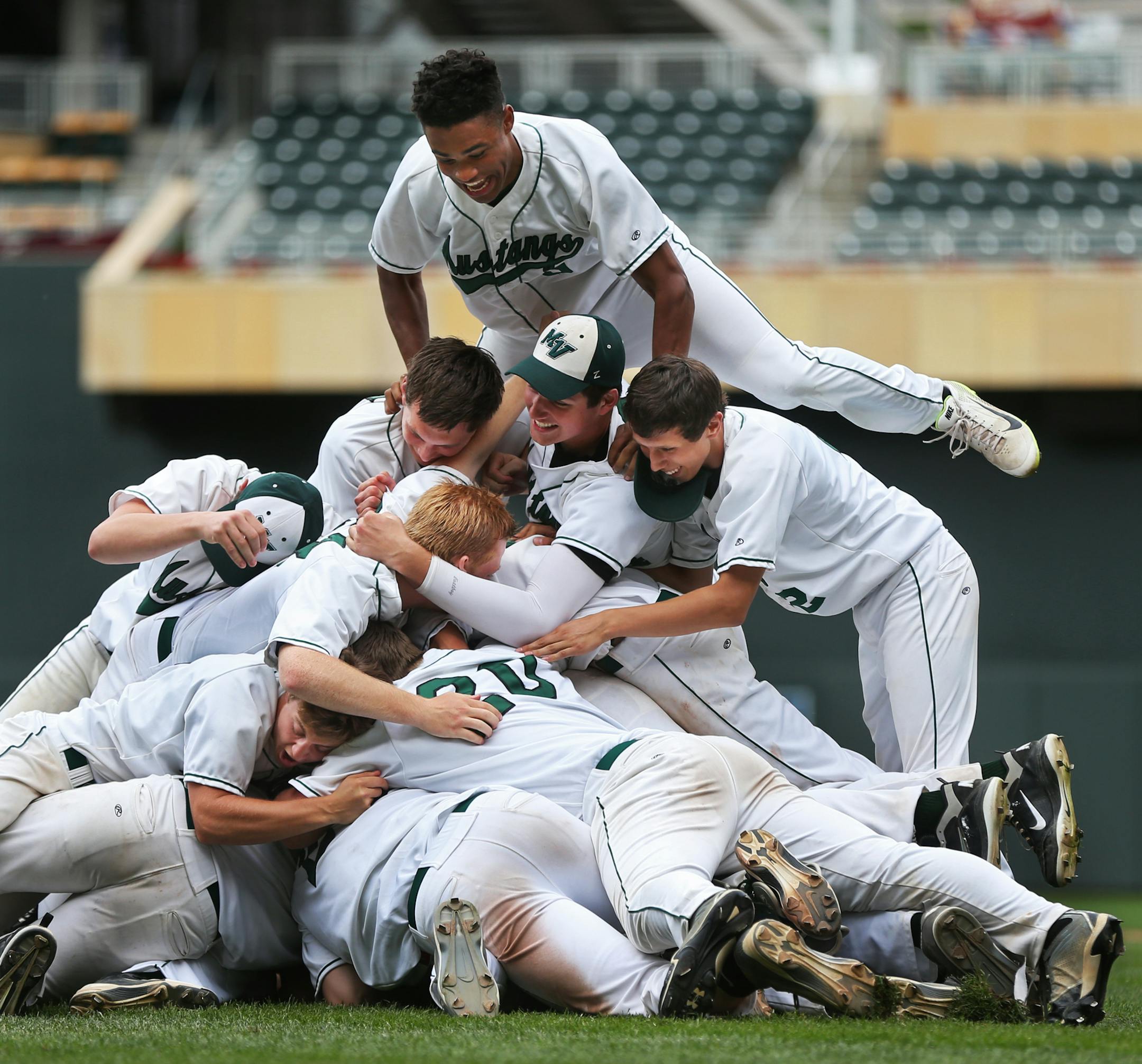 In the Class AAA baseball finals between Mounds View and Rocori at Target Field, Alec Abercrombrie jumped on the celebration pile after they took a 8-0 win. ] richard tsong-taatarii@startribune.com