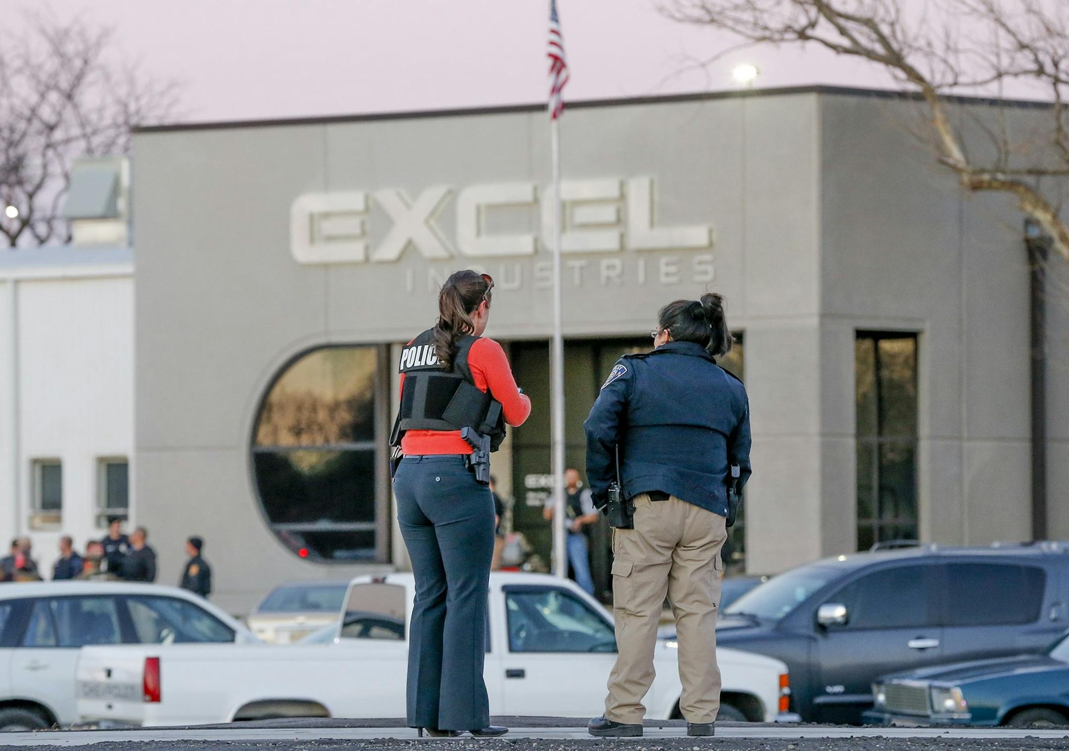 Police guarded the front door of Excel Industries in Hesston, Kan., which was part of a series of shootings that left four people dead, including the gunman.