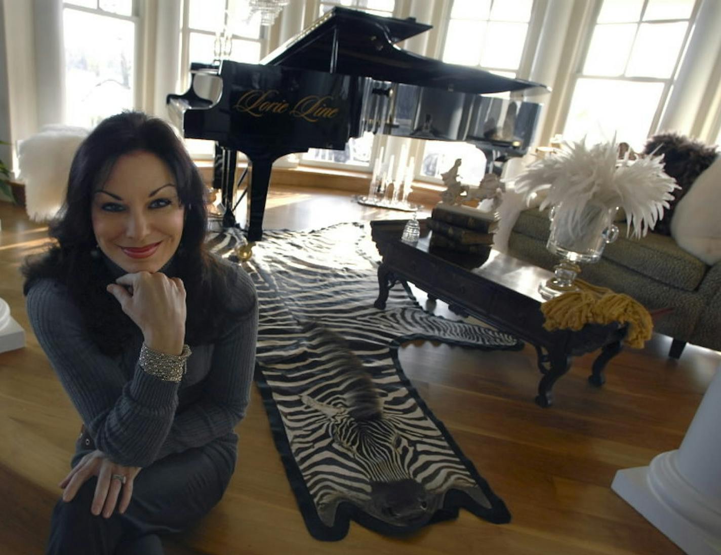 Pianist Lorie Line on the steps of the round room with her piano and a view of the lake in 2007.