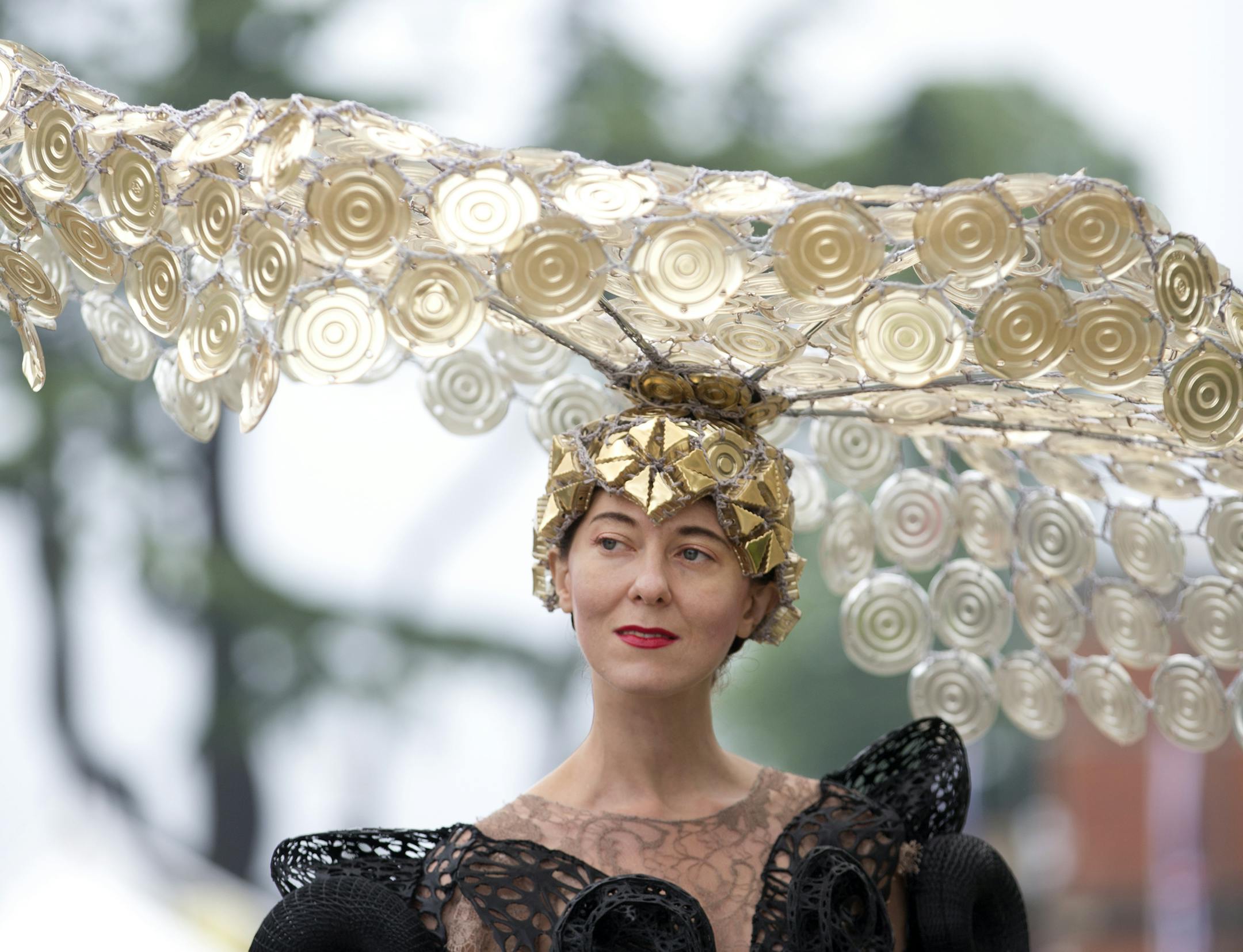 Larisa Katz poses for the media wearing an ornate hat on the third day traditionally known as Ladies Day of the Royal Ascot horse race meeting in Ascot, England, Thursday, June 20, 2013. (AP Photo/Alastair Grant)