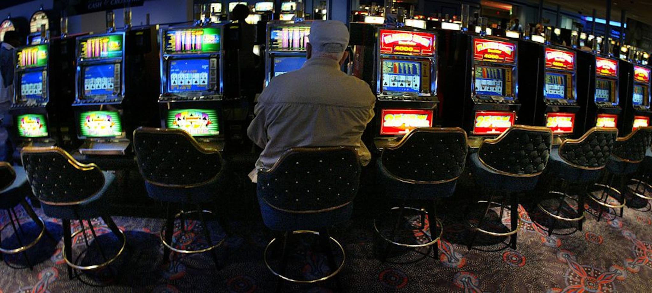 Jim Gehrz/Star Tribune 3/25/04 Red Wing 1:00 PM Emil Karnitz, 80, Prior Lake, plays video poker at the Treasure Island Casino in Red Wing. The Casino and resort is run by the Prairie Lake Band.