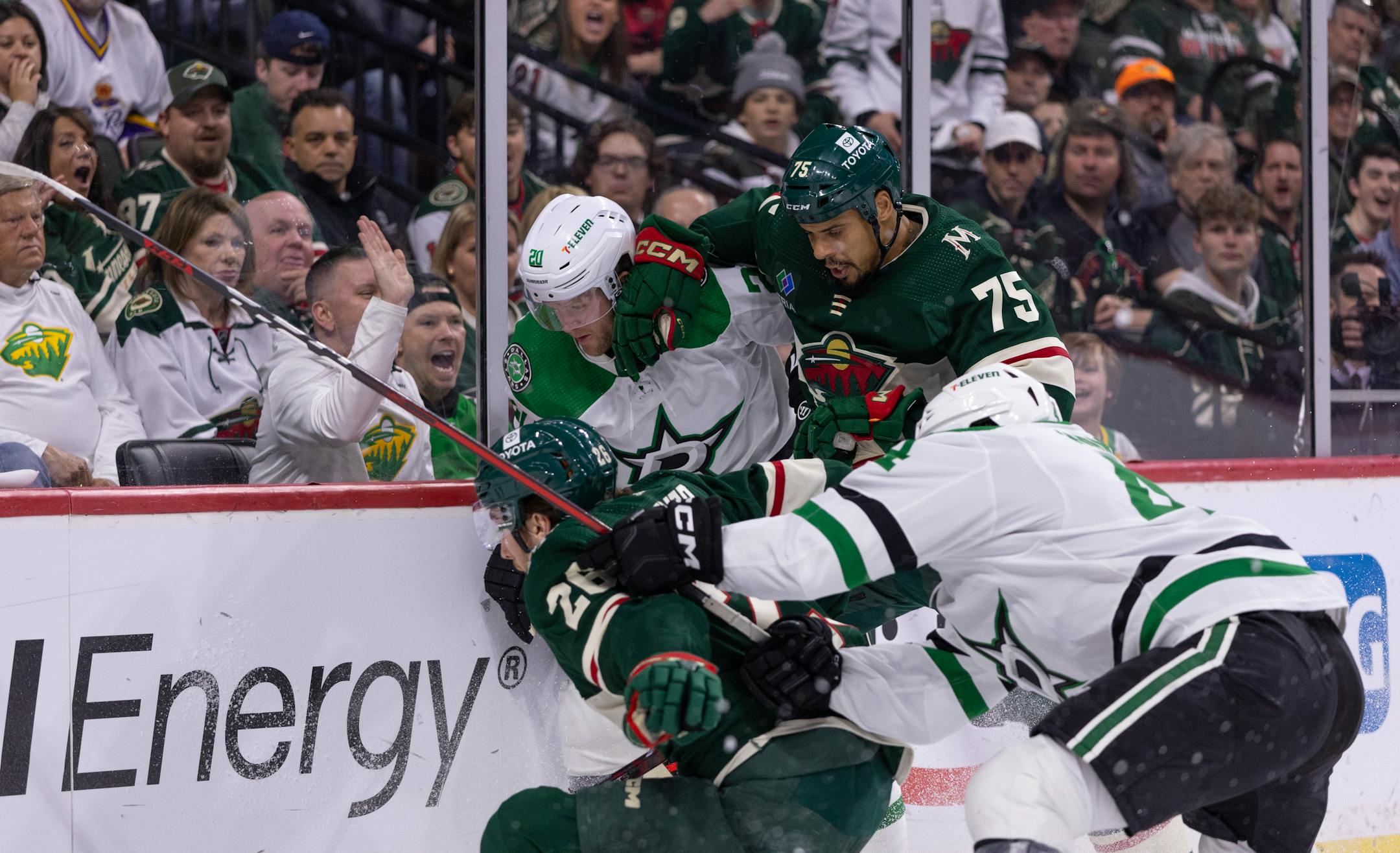 Minnesota Wild right wing Ryan Reaves (75) checked Dallas Stars defenseman Ryan Suter (20) into the boards in the first period.