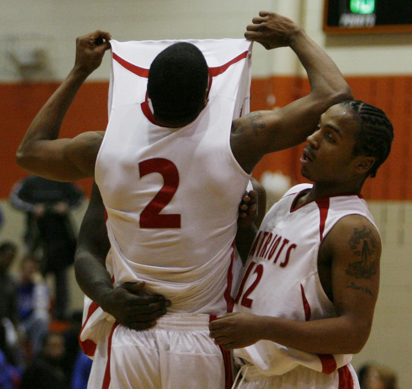 Patrick Henry's Mandela Jackson celebrated with teammate Jordan Hughes after their 85-75 boys' basketball section final victory over Spring Lake Park in March 2008.