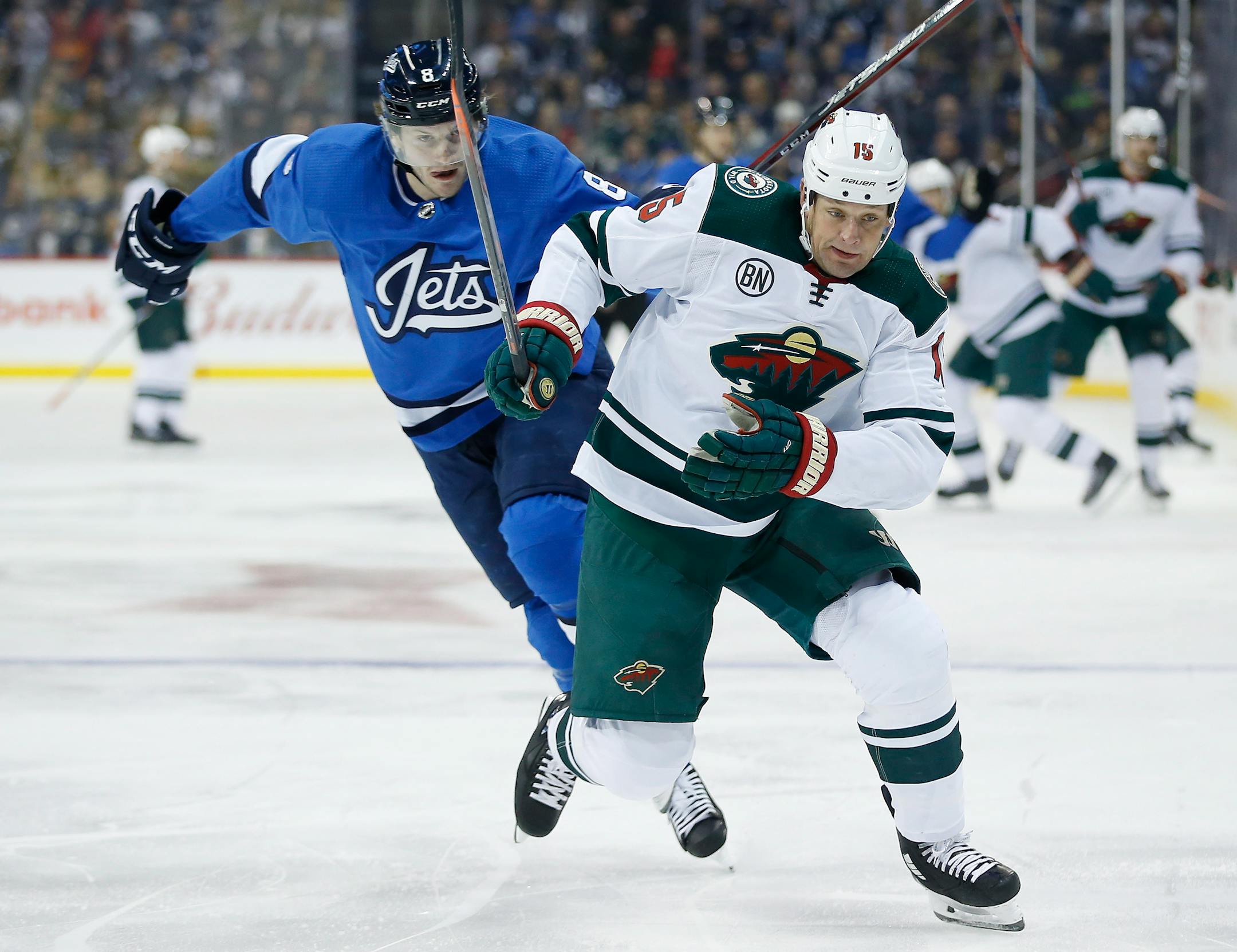 Winnipeg Jets' Jacob Trouba can't stop the Wild's Matt Hendricks as he skates past during first period Saturday