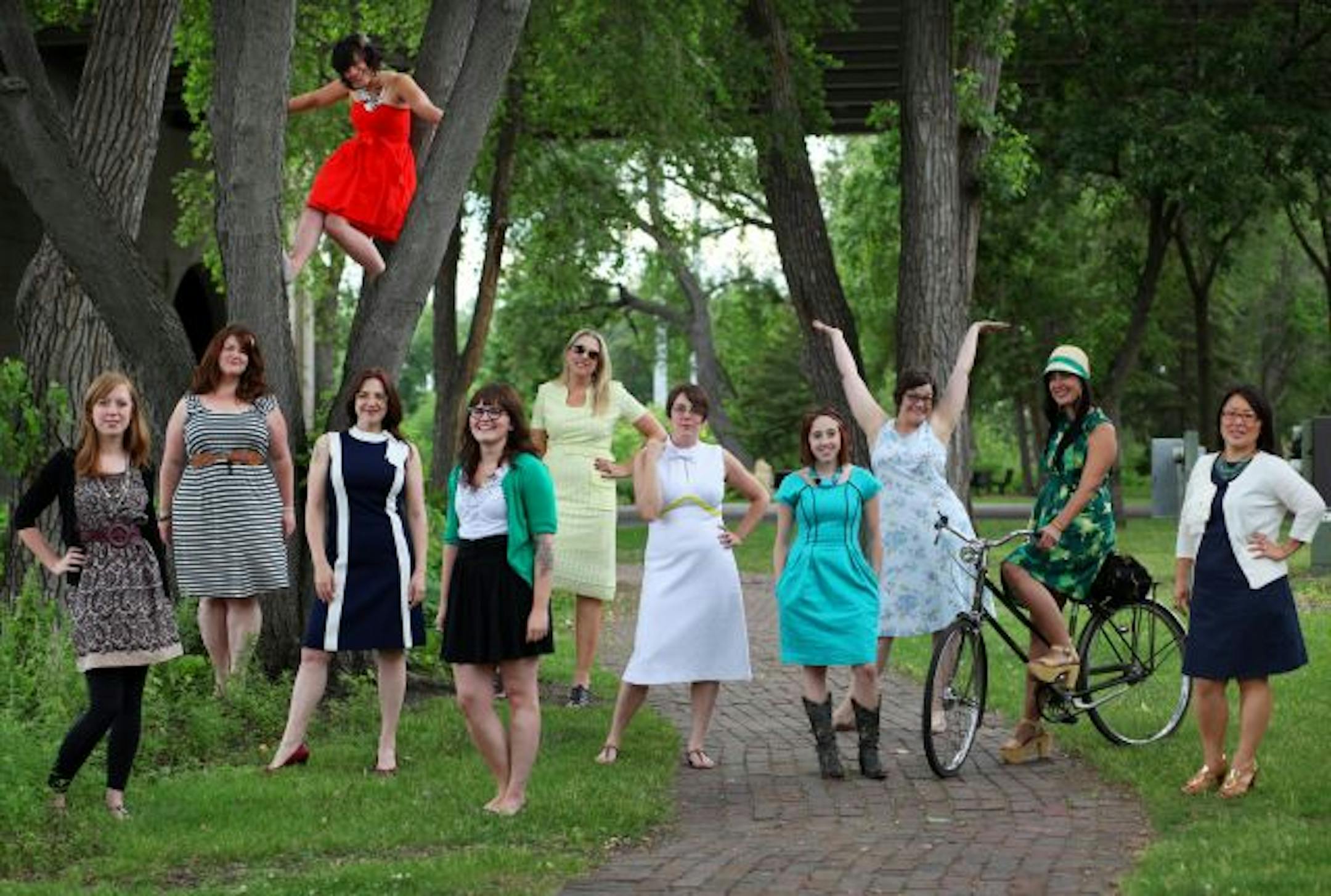 From tweet to street: An idea to wear more dresses this summer started on social media and has become reality for a group of local women. From the left, Keeley Dunn, Kate O'Reilly, Nicole Weiler (in the tree), Meghan Wilker, Chelsea Brink, Kris Huson, Megan Gamble, Nicky Stein-Grohs, Laura Brown, Liz Bastian and Sasha Westin came to a "Tweet up" near St. Anthony Main.