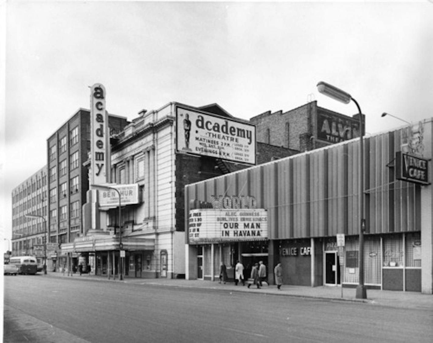 MINNEAPOLIS IN 1960 / The Academy Theatre, the World Theater, and the Venice Cafe / photo faces north / both theaters on northeast side of Seventh Street show running northwest between Hennepin Avenue (not visible off to lower right of photo) and First Avenue North (just beyond the bus at lower left of photo) / Star Tribune staff file photo April 1960 by Minneapolis Star and Tribune photographer Roy Swan.