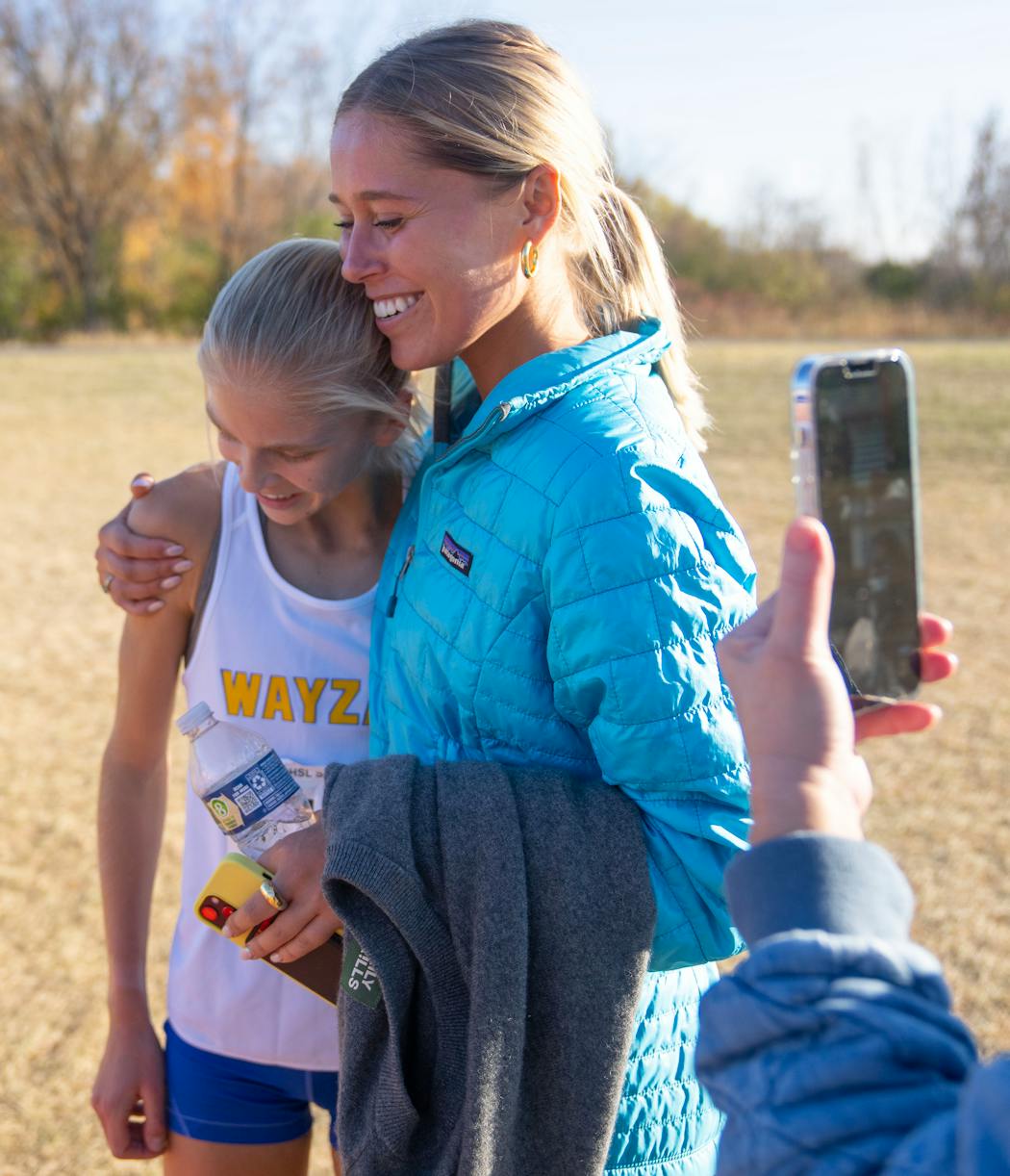 Abbey Nechanicky got a hug from sister Riley after winning her section race. 