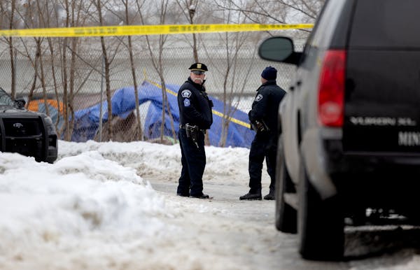 Police officers at the scene of a homicide at a homeless encampment in the Cedar Riverside area Thursday, January 12, 2023, in Minneapolis.