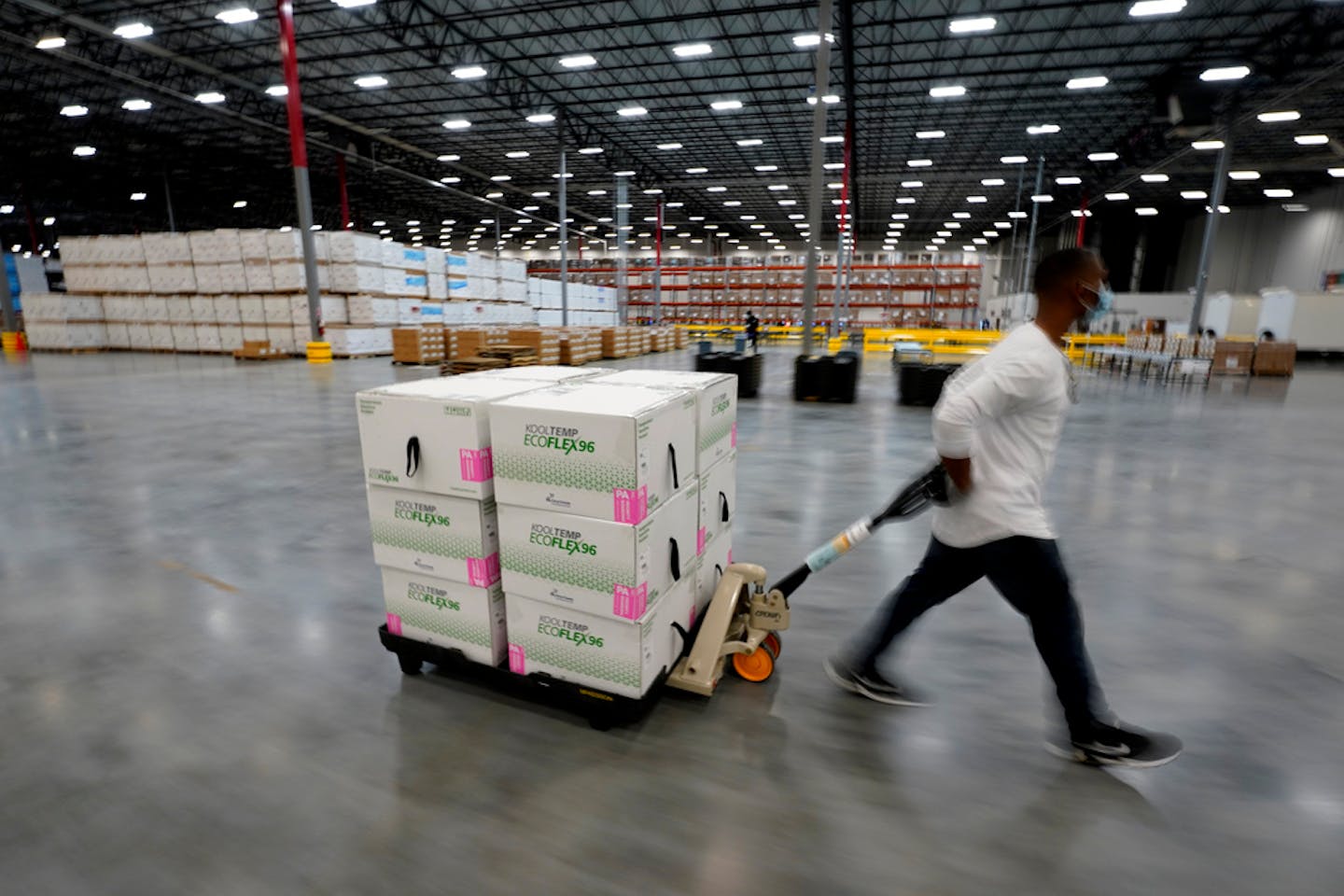 Boxes containing the Moderna COVID-19 vaccine are moved to the loading dock for shipping at the McKesson distribution center in Olive Branch, Miss., Sunday, Dec. 20, 2020. (AP Photo/Paul Sancya, Pool)