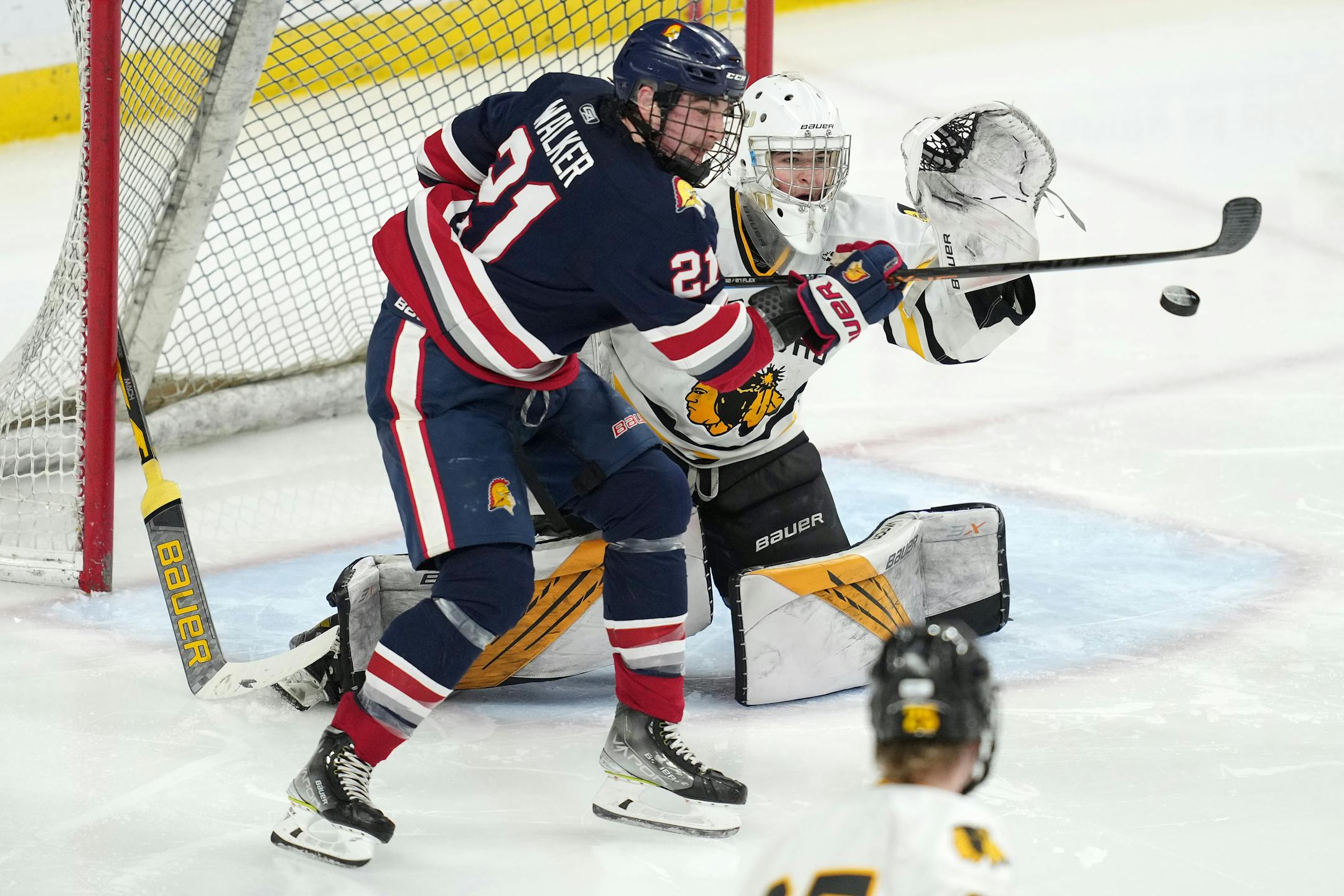Orono forward Bradley Walker (21) tries to deflect the puck in as Warroad goaltender Hampton Slukynsky (1) looks to make a glove save after his stick got caught in the net in the second period.