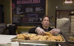 Chris Engelmann gathered fresh unsold donuts Tuesday from the SugaRush bakery May 10, 2016 in St. Paul, MN.] Chris Engelmann loaded donuts from the Su