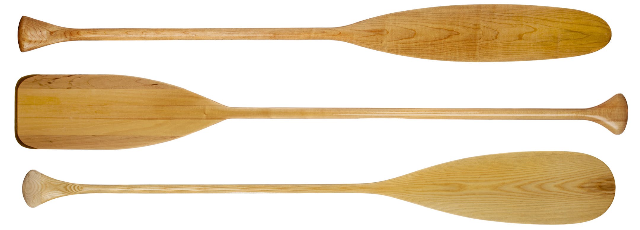 three wooden canoe paddles with different shape of blades including traditional beaver tail, isolated on white, istock