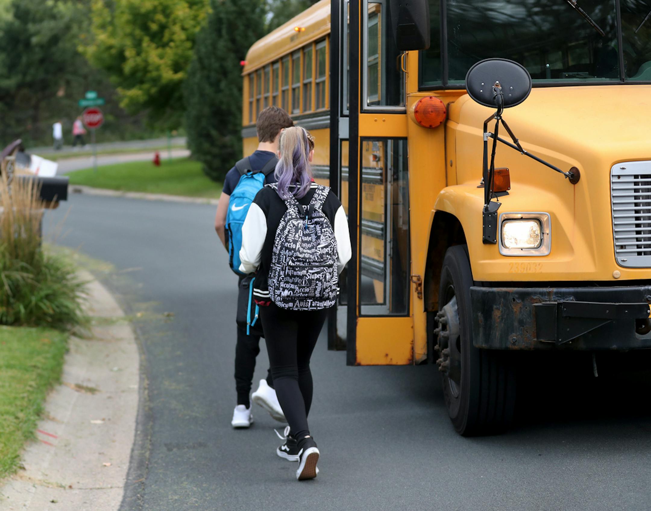 Students walk to board a school bus nicknamed "the secret bus," since these kids are basically doing reversed bussing, where they are leaving their school district to go to a different one. In this case, the students are leaving Eden Prairie to be bussed to the Minnetonka district, they attend school and were seen Thursday, Sept. 7, 2017, in Eden Prairie, MN.]