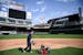 Grounds crew member Reid Olson cut the grass near second base last month at Target Field.