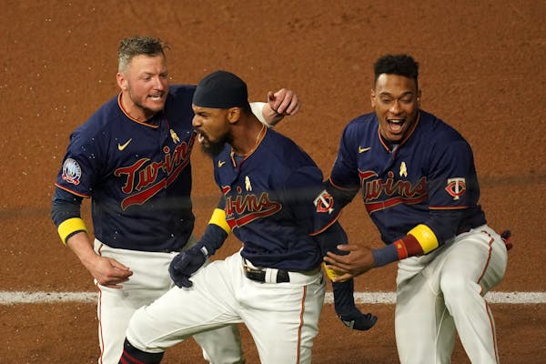 Twins center fielder Byron Buxton was mobbed by third baseman Josh Donaldson (24) and shortstop Jorge Polanco (11) after he hit the game-winning singl