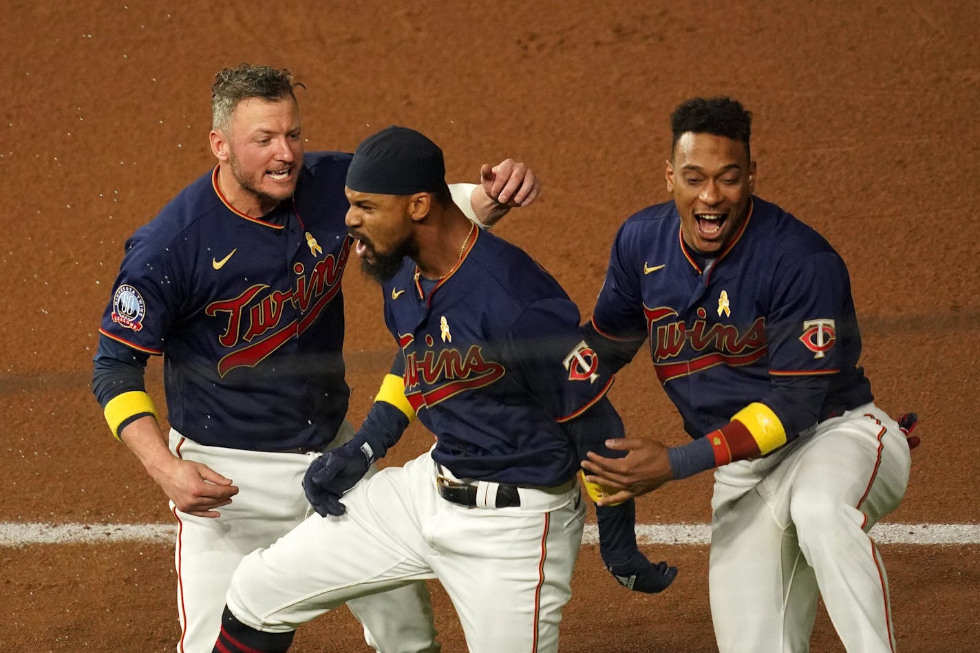 Twins center fielder Byron Buxton was mobbed by third baseman Josh Donaldson (24) and shortstop Jorge Polanco (11) after he hit the game-winning single.