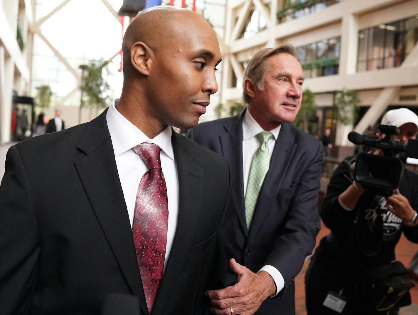 Mohamed Noor, accompanied by his legal team, Peter Wold, and Tom Plunkett left after a probable cause hearing for the ex-Minneapolis cop Thursday at the Hennepin County Government Center.