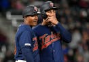 Minnesota Twins Eddie Rosario talks with third base coach Tony Diaz during the fourth inning in the second baseball game of a doubleheader, Saturday, 