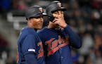 Minnesota Twins Eddie Rosario talks with third base coach Tony Diaz during the fourth inning in the second baseball game of a doubleheader, Saturday, 