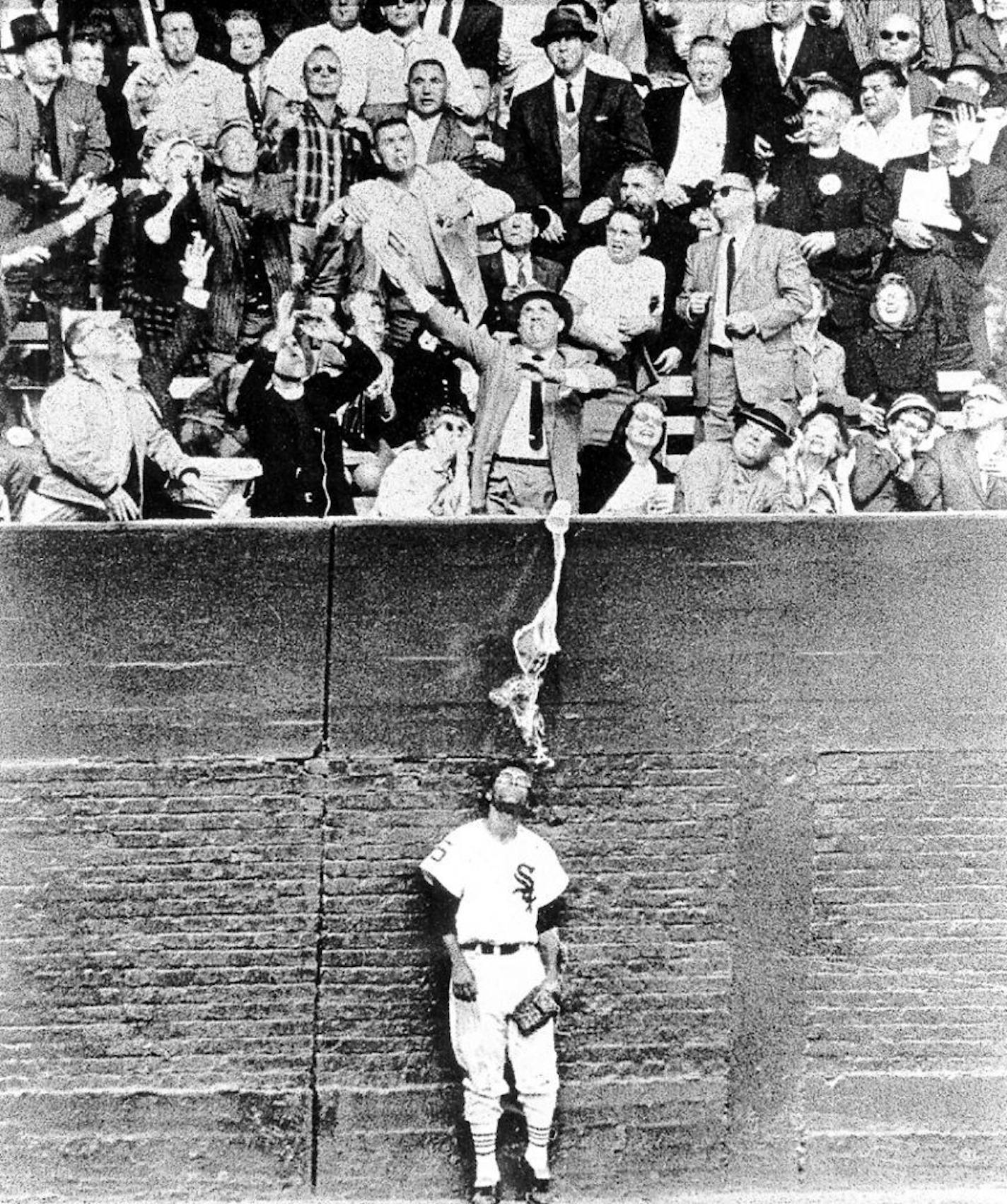 FILE - A Chicago Sun-Times photographer captured this memorable image in the 1959 World Series, when Chicago White Sox outfielder Al Smith took a beer bath as fans reached for a home run ball at Comiskey Park.