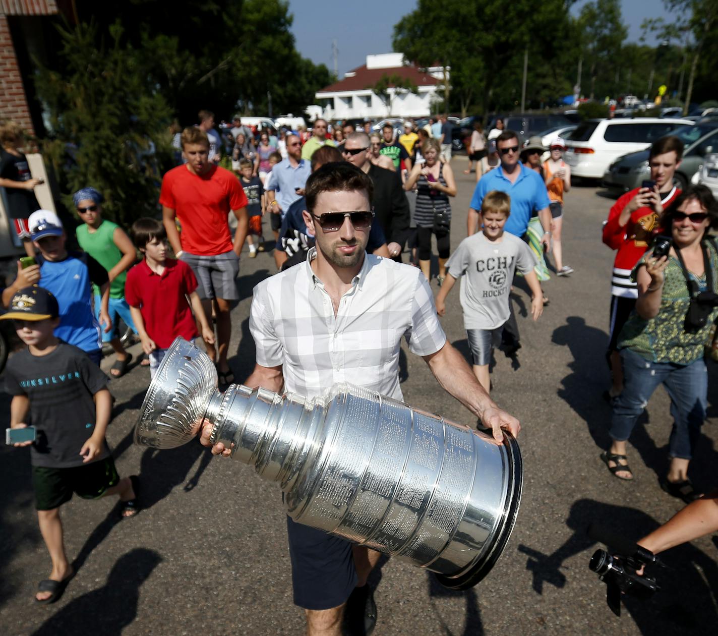 After arriving at Maynard's in Excelsior Nick Leddy of the Chicago Blackhawks held the Stanley Cup as he made his way to the outdoor deck. Leddy is from Eden Prairie, Minn. ] CARLOS GONZALEZ cgonzalez@startribune.com July 11, 2013, Excelsior, Minn., Maynard&#x201a;&#xc4;&#xf4;s The Stanley Cup comes with Nick Leddy to Maynard's. NHL