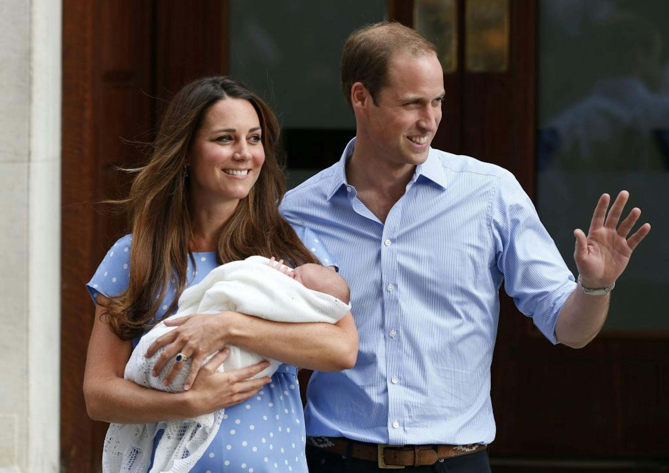 Britain's Prince William and Kate, Duchess of Cambridge hold the Prince of Cambridge, Tuesday July 23, 2013, as they pose for photographers outside St. Mary's Hospital exclusive Lindo Wing in London where the Duchess gave birth on Monday July 22. The Royal couple are expected to head to London�s Kensington Palace from the hospital with their newly born son, the third in line to the British throne.