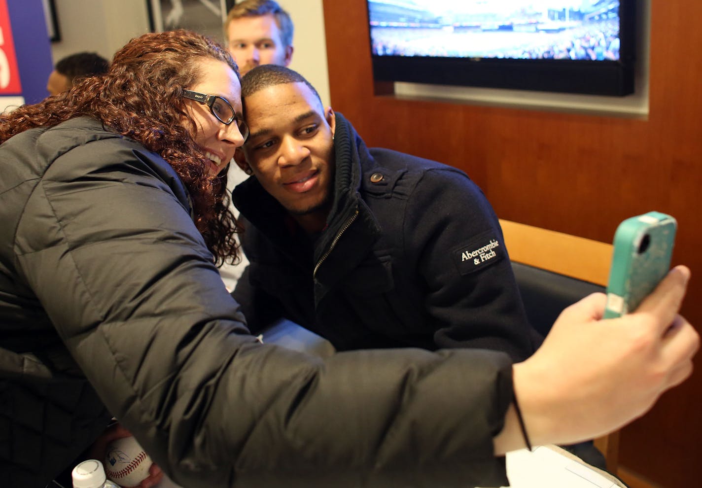 Betty Miller of River Falls, Wis., got her picture taken with 20-year-old Byron Buxton during the first day of TwinsFest at Target Field on Friday.