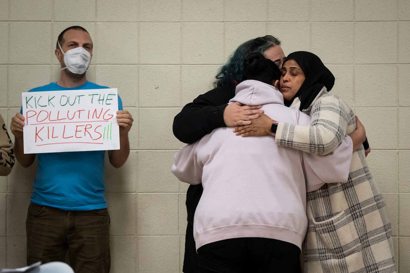 Rep. Aisha Gomez (DFL) District 62A and Rep. Hodan Hassan (DFL) District 62B embrace Cassandra Holmes after she spoke about the death of her son from heart disease he deleloped as a teen during a heated community meeting with the MPCA and the EPA at the Phillips Community Center on Monday, Nov. 27, 2023 in Minneapolis, Minn. Holmes was one of several Little Earth residents that expressed discomfort with the oders and dust believed to be from the Smith Foundry nearby. ] RENEE JONES SCHNEIDER • renee.jones@startribune.com