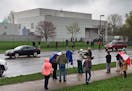 FILE - In this April 21, 2016 file photo, people stand outside entertainer Prince's Paisley Park compound in Chanhassen, Minn. Court filings in Prince