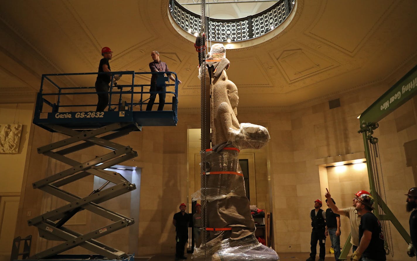 Staff at the Minneapolis Institute of Art installed an Egyptian statue for a 2018 exhibit.