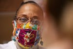 Dr. Verna Thornton spoke with a patient while donning her Wonder Woman face mask recently at Community Memorial Hospital in Cloquet, Minn.